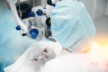 Lasik treatment operation, laser vision correction. Doctor examines fundus in microscope, patient...