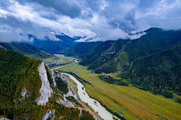 Fototapeta premium Aerial top view beautiful landscape mountains with fog, green forest and trees in rural Altai, drone photo