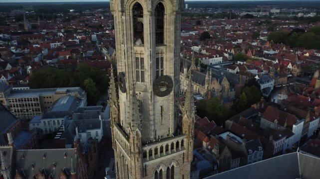 Explore the stunning Belfry of Brugge towering at sunset