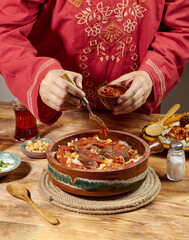 A woman is preparing Egyptian Fatta 