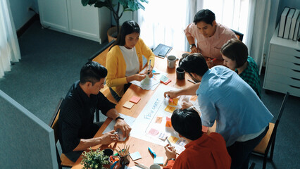 Top down view of diverse people brainstorming and making scrum task board. Group of skilled...