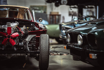 Classic cars being restored in a vintage vehicle garage workshop