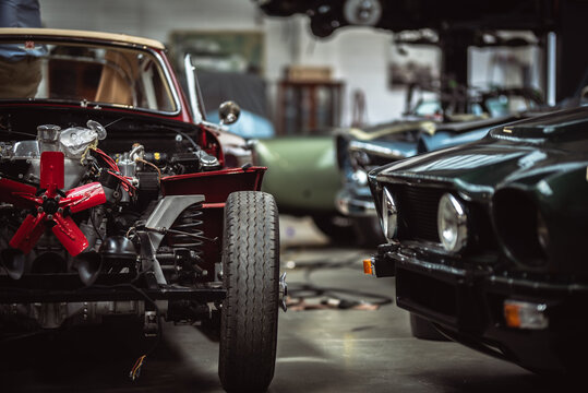Fototapeta Classic cars being restored in a vintage vehicle garage workshop