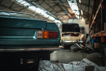 Classic cars being restored in a vintage vehicle garage workshop