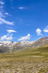 Panoramic view on snowy mountains on hiking trail to Mulhacen peak in the spring, Sierra Nevada range, Andalusia, Spain