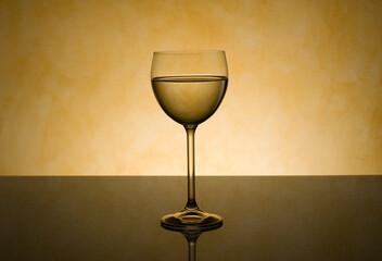 A transparent crystal glass of white wine  reflecting a clean liquid glow perfect for a celebration, restaurant drink, or elegant party beverage