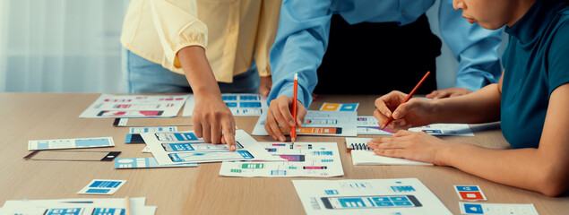 Panorama banner of startup company employee planning on user interface prototype for mobile application or website in office. UX UI designer brainstorm user friendly interface plan. Synergic