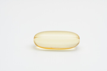 Transparent soft gel oil capsule on light grey background