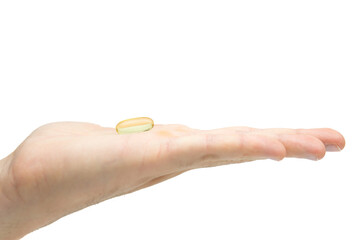 Male hand holding omega 3 soft gel capsule isolated on white background