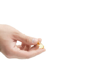 Male hand holding omega 3 soft gel capsule isolated on white background