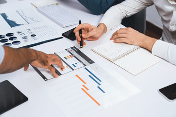 Project manager communicate and collaborate with team using project management software display on monitor, tracking progress of project task and making schedule plan at meeting table. Prudent