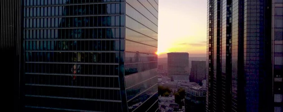 
As the sun begins to set over London, the city's iconic skyline is bathed in a warm, golden glow. From a drone's aerial perspective, the skyscrapers rise majestically, their glass facades reflecting 