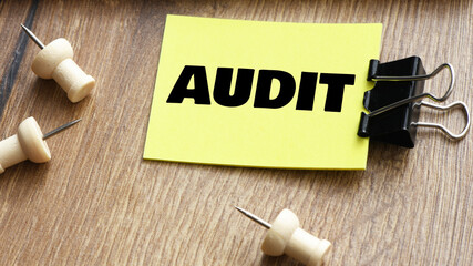 AUDIT word on a small piece of paper.