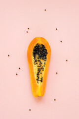 Papaya fruit on pink background. Food concept. Top view, flat lay
