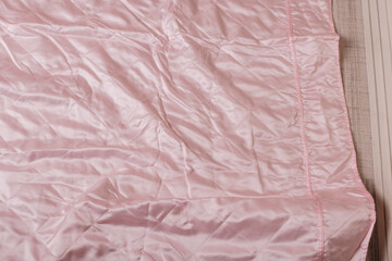 A pink bedspread featuring ruffles, great for showcasing in interior design themes or bedding...
