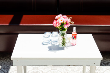 Bouquet of spring pink flowers in vintage glass vase. Decorative elements of interior. still life vibe.