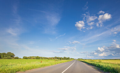 Fototapeta premium A long road with a clear blue sky above it