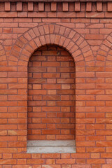 Background of patterned brick wall with arch shape.