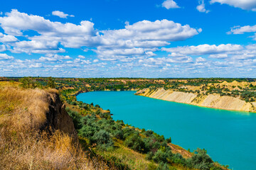 Lake with sandy shore in the abandoned coal quarry