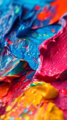 Fototapeta premium Colorful abstract paint with vibrant blue, pink, and yellow swirls in close-up view