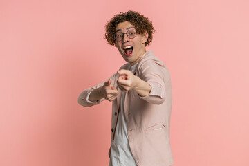 Happy mime Caucasian curly haired man in jacket pulling an imaginary unreal invisible rope, puts...