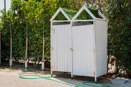 Outdoors beach changing rooms in greece next to a beach and showers for washing away the salt water