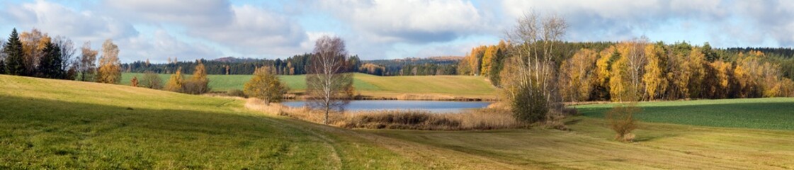 autumn view of pond with autumn forest landscape