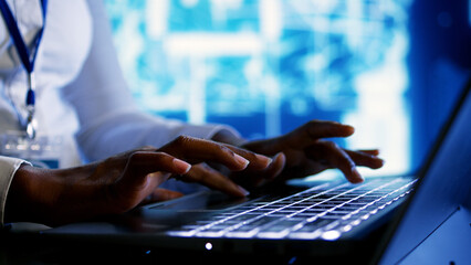 Trained specialist using laptop to maintenance artificial intelligence neural networks made up of artificial neurons. System administrator using AI system aiding in processing information, close up