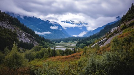 A Majestic View of Mountains and Lush Valley Under Clouds