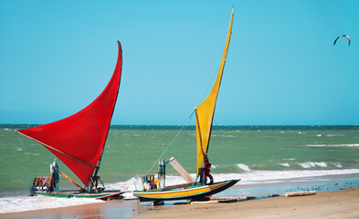 Jangada, or raft, a rustic wooden boat with a sail, typically used for fishing and recently for...