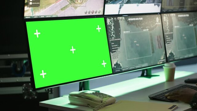 Soldier in military HQ base using green screen equipment to gather information on enemy troops. Officer using chroma key devices to do assessment of enemy vulnerabilities, camera A