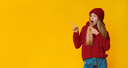 Stunned blonde woman looking and pointing at copy space, shocked offer, panorama