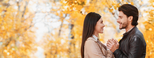 Declaration of love. Beautiful lovers standing against each other, hollding hands, declare their...