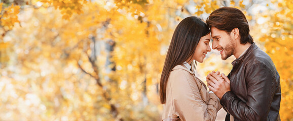 Man in love making confession to his girlfriend in beautiful autumn forest