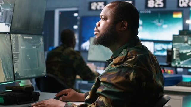 Army operative in command center analyzing surveillance data during global warfare. Intelligence agent in base of operations completes mission during World War 3 geopolitical operation, camera A