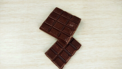 Two chocolate bars on wooden table with copy space

