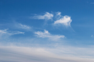 gentle white clouds in the blue sky
