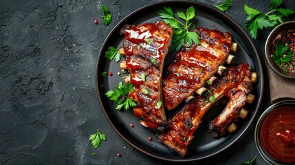 Grilled spare ribs on a plate with sauce from a summer BBQ with a top view and copy space