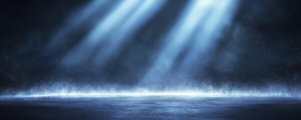 Abstract blue light rays illuminating foggy dark space with spotlight on empty asphalt floor, creating a mysterious atmosphere for product presentation or branding concepts.
