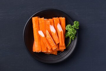 Crab sticks on plate with black background, Top view © nungning20