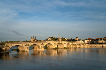 Fototapeta premium View of the embankment with ancient houses and the Jacques Gabriel Bridge over the Loire River on a sunny summer day, Blois, Loire and Cher, France