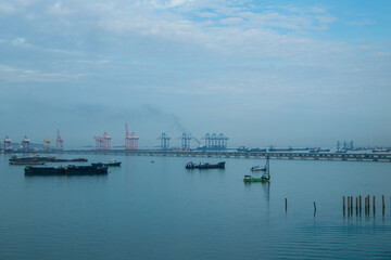 Logistic shipping quay boat Engineering crane depot at logistic export terminal control. Warehouse freight background container yard loading quayside harbor port. Logistics seascape shipping portal