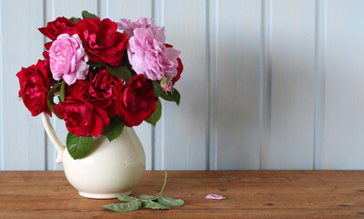 bouquet of roses as a background, copy space. garden red and pink climbing roses. natural backdrop.