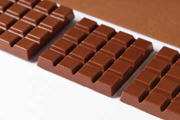Composition with tasty chocolate bars on color background, closeup