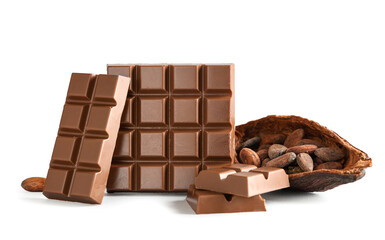 Tasty chocolate bars and cocoa beans on light background