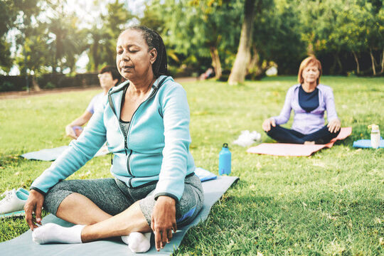 Meditation, Senior people enjoy yoga meditation training in nature park. Harmony, focus, wellness life style concept