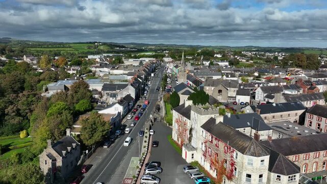 Carrickmacross Town, County Monaghan, Ireland, November 2022. Drone pushes north above St Finbarr&rsquo;s Church of Ireland over the main street revealing houses along both sides of the rural market town.