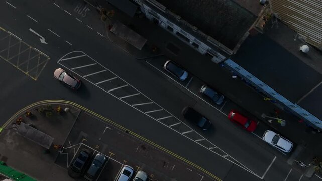 Carrickmacross Town, County Monaghan, Ireland, November 2022. Drone in Bird's Eye View pushes along main street following cars driving through the rural market town.
