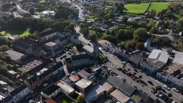 Carrickmacross Town, County Monaghan, Ireland, November 2022. Drone orbits counter clockwise above St Finbarr&rsquo;s Church of Ireland and Convent of St Louis with cars drive along the rural main street.