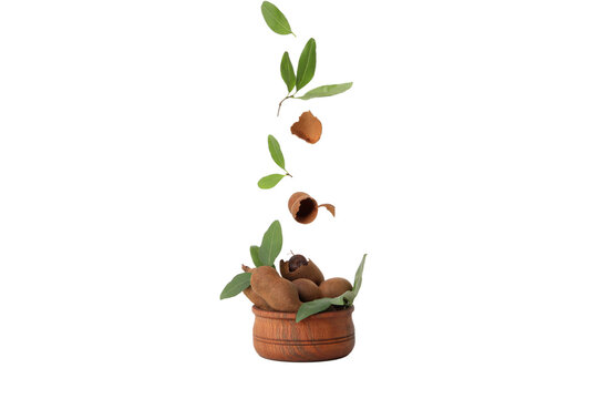 PNG, Ripe tamarind with leaves in a bowl, isolated on white background